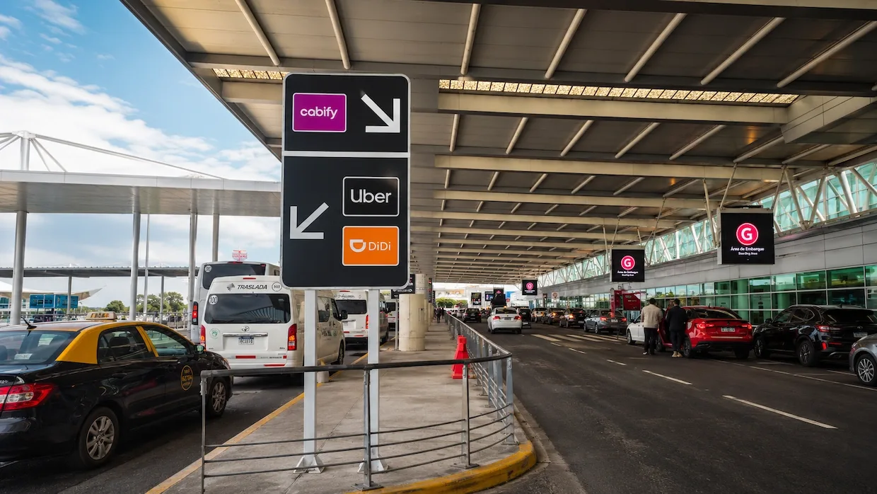Rideshare pickup signs for Cabify, Uber and DiDi at Ezeiza arrivals