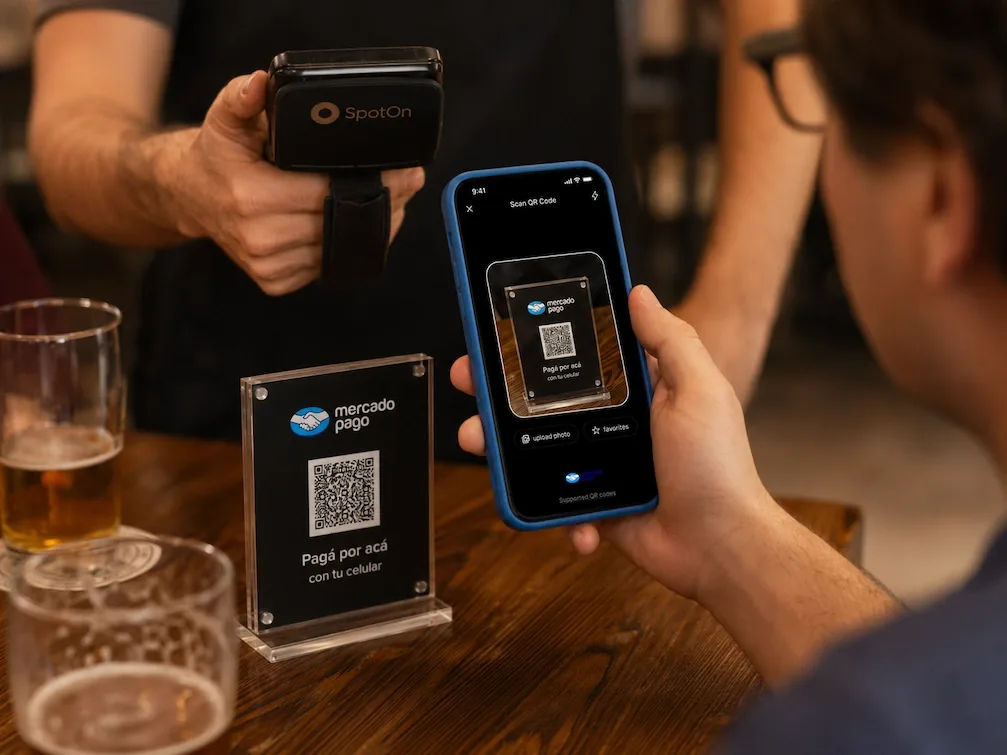 Scanning a Mercado Pago table QR with a phone in a Buenos Aires bar.