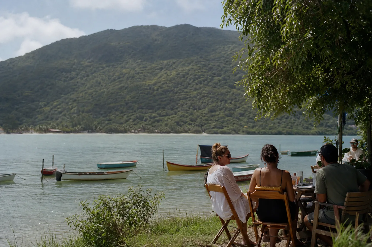 The lagoon at Lagoa da Conceição in Florianópolis, small boats moored near the shore with green hills rising behind