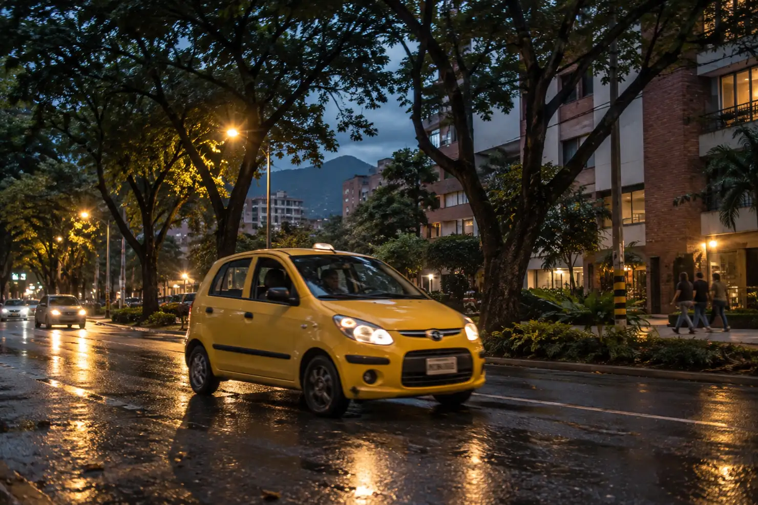 A yellow taxi on a wet, tree-lined Laureles street at night, streetlights reflecting off the road and pedestrians walking past lit apartment buildings