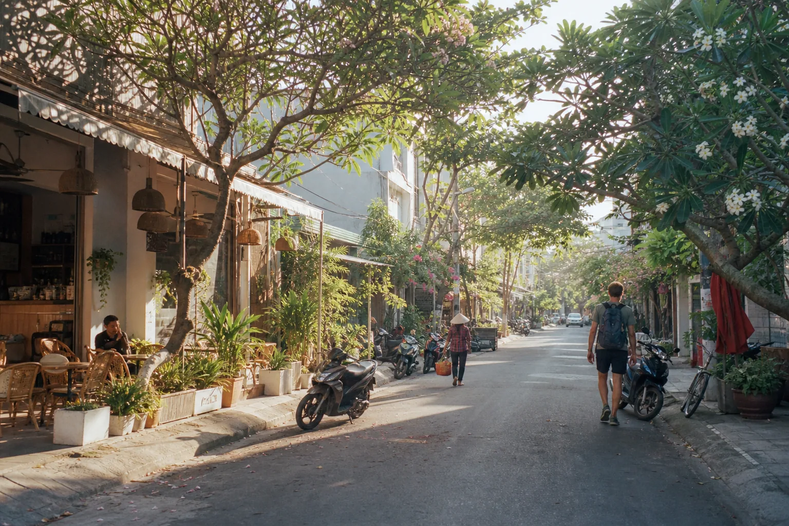 A leafy An Thượng street in Da Nang lined with laptop cafes and parked motorbikes, two streets back from the beach