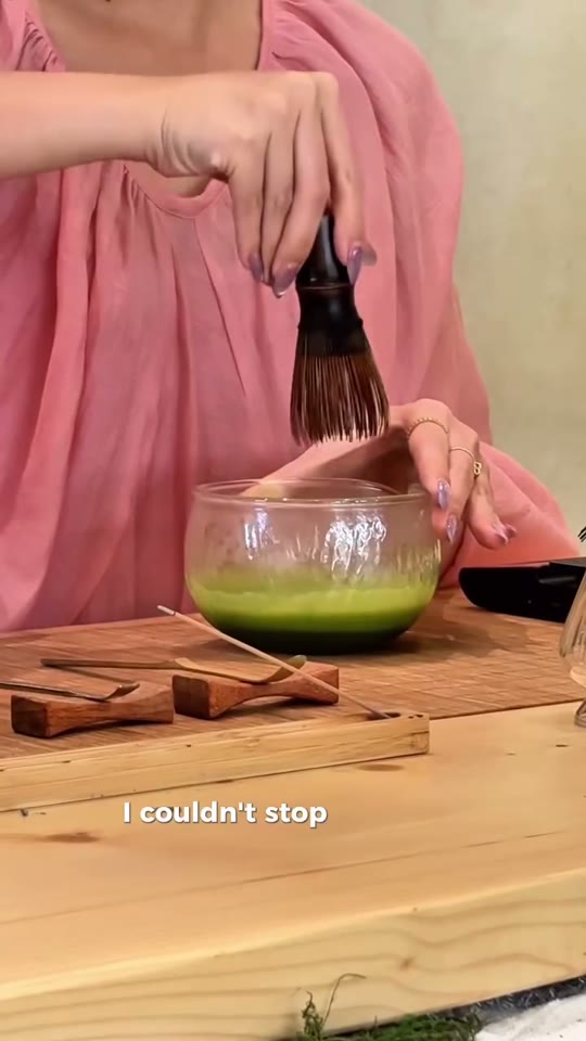 A creator pours matcha into a wine glass with a hand-drawn face at Uncha Matcha, a whimsical cafe in Da Nang.