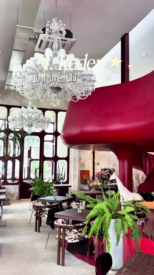A red spiral staircase winds through a dramatic dining room at Reden, one of Da Nang’s most photogenic restaurants.